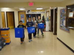 Students bringing recyclables from the classroom.
