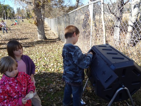 Students add compost from classroom lunches